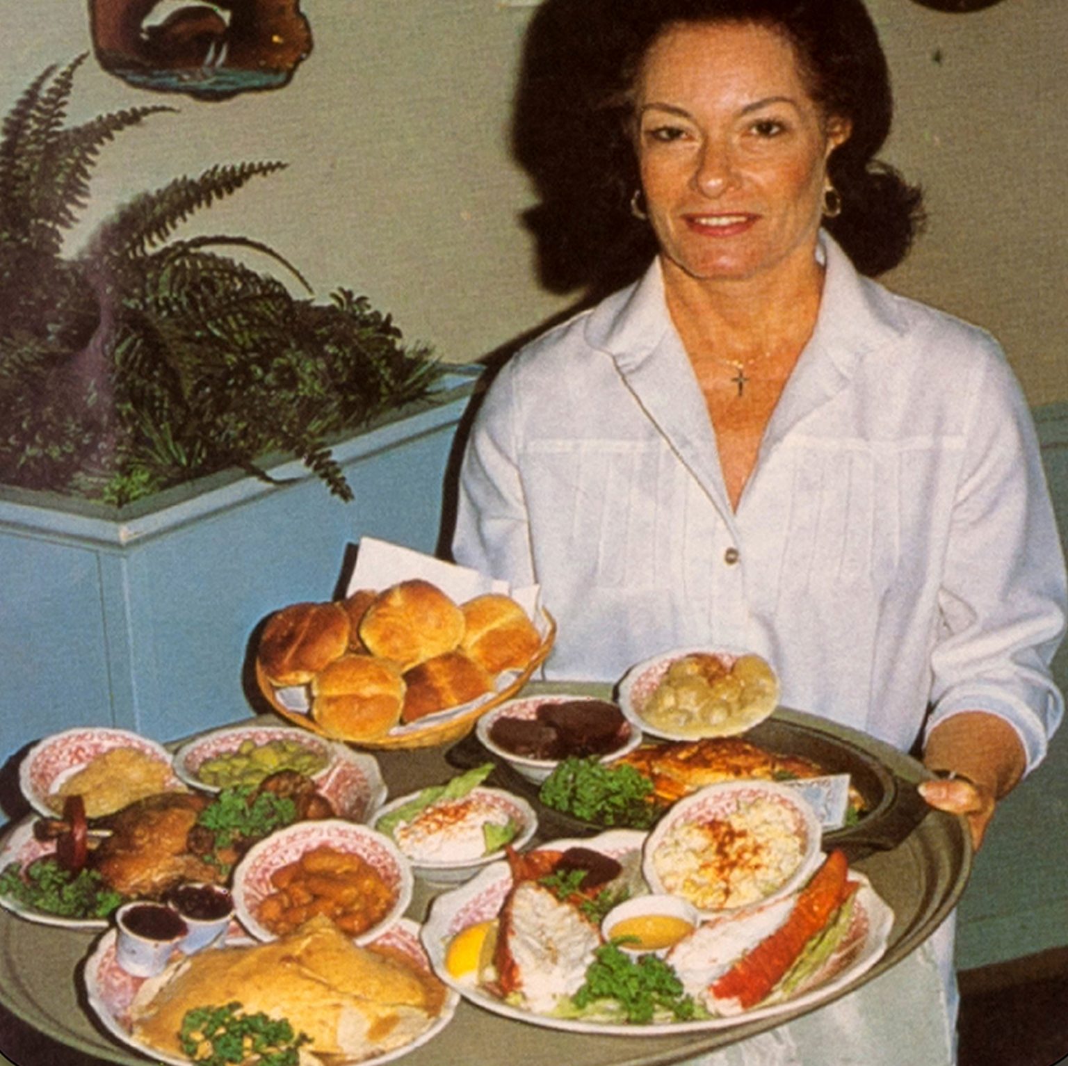 waitress with tray of food, 1970s or 80s